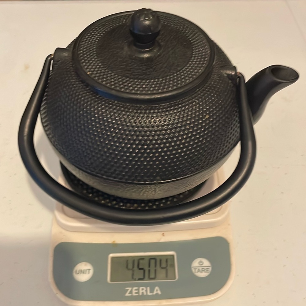 Cast iron kettle w/ hot plate and tea basket.